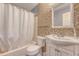 Cozy bathroom featuring a tiled wall, white vanity, toilet, and a bathtub with a shower curtain at 1743 Orange Grove Shores Dr, Charleston, SC 29407