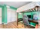 Unique bedroom featuring hardwood floors, a lofted bed above a desk with computer, and closet at 1743 Orange Grove Shores Dr, Charleston, SC 29407