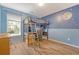 A bedroom with playful blue walls with moon designs and a lofted bed above a desk with computers at 1743 Orange Grove Shores Dr, Charleston, SC 29407