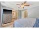 Bedroom showcasing hardwood floors, a ceiling fan, dresser, and a view into an ensuite bathroom at 1743 Orange Grove Shores Dr, Charleston, SC 29407