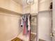 Walk-in closet featuring built-in shelving, hanging rods, hardwood flooring, and a full-length mirror at 1743 Orange Grove Shores Dr, Charleston, SC 29407