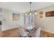 Bright dining area featuring a modern light fixture and natural light from sliding glass door at 1743 Orange Grove Shores Dr, Charleston, SC 29407