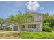 Attractive two-story home with a covered front porch, attached garage, and lush lawn at 1743 Orange Grove Shores Dr, Charleston, SC 29407