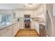 Well-appointed kitchen with stainless appliances, ample counter space, and white cabinetry at 1743 Orange Grove Shores Dr, Charleston, SC 29407