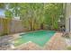 Backyard swimming pool surrounded by mature trees and stone pavers perfect for outdoor relaxation and entertainment at 1743 Orange Grove Shores Dr, Charleston, SC 29407