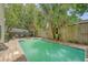 Backyard swimming pool surrounded by mature trees and stone pavers is perfect for outdoor relaxation and enjoyment at 1743 Orange Grove Shores Dr, Charleston, SC 29407