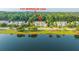 An aerial view of the townhouses, surrounded by lush greenery and a serene lake at 1751 Brittlebush Ln, Johns Island, SC 29455