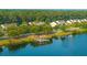 Breathtaking aerial view of pond-side townhomes surrounded by trees with a gazebo dock at 1751 Brittlebush Ln, Johns Island, SC 29455
