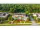 An aerial view showcasing the condo's layout amidst lush greenery and community streets at 1751 Brittlebush Ln, Johns Island, SC 29455