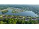 Breathtaking aerial view of lakefront homes nestled among lush trees and landscaping at 1751 Brittlebush Ln, Johns Island, SC 29455
