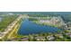 Expansive aerial view showcasing a community surrounding a serene lake and lush greenery at 1751 Brittlebush Ln, Johns Island, SC 29455