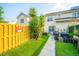A charming backyard offers a tranquil outdoor space with artificial turf and a fenced perimeter for privacy at 1751 Brittlebush Ln, Johns Island, SC 29455