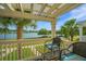 Balcony with water view, seating for two, and mature landscaping at 1751 Brittlebush Ln, Johns Island, SC 29455