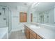 Bathroom with large mirror, shower, and vanity with light wood cabinets at 1751 Brittlebush Ln, Johns Island, SC 29455