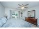 Primary bedroom featuring ceiling fan, hardwood floors, a water view balcony, and dresser at 1751 Brittlebush Ln, Johns Island, SC 29455