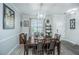 Bright dining room with a modern chandelier, window, and seating for six at 1751 Brittlebush Ln, Johns Island, SC 29455