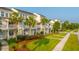 A street view of the condos with well-maintained lawns, tropical landscaping, and welcoming porches at 1751 Brittlebush Ln, Johns Island, SC 29455