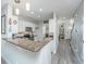 Open kitchen with a peninsula, bar-top counter, white cabinets, and modern appliances at 1751 Brittlebush Ln, Johns Island, SC 29455