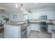Bright kitchen with white cabinets, granite countertops, stainless steel appliances, and hardwood floors at 1751 Brittlebush Ln, Johns Island, SC 29455