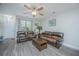 Comfortable living room with ceiling fan, hardwood floors and two leather couches at 1751 Brittlebush Ln, Johns Island, SC 29455
