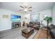 Living room featuring a ceiling fan, hardwood floors, fireplace and two leather couches at 1751 Brittlebush Ln, Johns Island, SC 29455