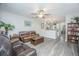 Open living room with view into kitchen featuring hardwood floors and comfortable seating at 1751 Brittlebush Ln, Johns Island, SC 29455