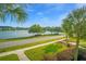 Exterior shot of the sidewalk in front of community, showcasing the landscaping and lake at 1751 Brittlebush Ln, Johns Island, SC 29455