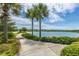 Scenic walking path with palm trees along the lake at 1751 Brittlebush Ln, Johns Island, SC 29455