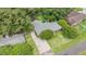 An aerial view showcases the well-maintained yard of a brick home shaded by mature trees at 1833 St Julian Dr, Charleston, SC 29407