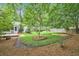 Private backyard with a small deck, mature trees, and a wooden fence at 1833 St Julian Dr, Charleston, SC 29407