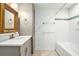 A beautifully renovated bathroom with a marble vanity and subway tile shower at 1833 St Julian Dr, Charleston, SC 29407