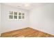 Bright bedroom with hardwood floors and white trim, featuring a large window with natural light at 1833 St Julian Dr, Charleston, SC 29407