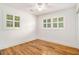 Bedroom with hardwood floors, ceiling fan, and bright windows at 1833 St Julian Dr, Charleston, SC 29407