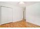 A cozy bedroom features hardwood floors, a ceiling fan, and a closet for ample storage at 1833 St Julian Dr, Charleston, SC 29407