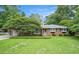 Charming brick home with a lush green lawn and mature landscaping creating inviting curb appeal at 1833 St Julian Dr, Charleston, SC 29407