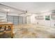A spacious garage features a large roll-up door and ample storage shelves for organization at 1833 St Julian Dr, Charleston, SC 29407