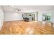 Open floor plan connecting the living area, kitchen, and sunroom with natural wood floors and neutral walls at 1833 St Julian Dr, Charleston, SC 29407