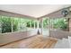 Bright sunroom with wood floor and views of the back yard through multiple windows at 1833 St Julian Dr, Charleston, SC 29407