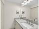 Bright bathroom featuring a granite countertop, white cabinetry, and a large mirror at 1948 Marsh Oak Ln, Seabrook Island, SC 29455