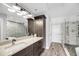 Beautiful bathroom featuring stone floors in shower, granite countertops, and a spacious walk in shower at 1948 Marsh Oak Ln, Seabrook Island, SC 29455