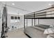 Loft bedroom featuring a bunk bed and large windows, offering views of the surrounding community at 1948 Marsh Oak Ln, Seabrook Island, SC 29455
