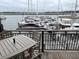 Outdoor deck with table and chairs overlooks boat docks at 1948 Marsh Oak Ln, Seabrook Island, SC 29455