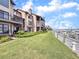 Beautiful condo building with landscaped lawn alongside a boardwalk and marina at 1948 Marsh Oak Ln, Seabrook Island, SC 29455