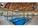 Bright indoor swimming pool with a wooden beamed ceiling and expansive windows at 1948 Marsh Oak Ln, Seabrook Island, SC 29455