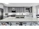 Stylish kitchen features gray cabinets, stainless steel appliances, a wine rack, and a large island with a white countertop at 1948 Marsh Oak Ln, Seabrook Island, SC 29455