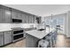 Modern kitchen featuring a large island with seating, stainless steel appliances, and ample storage at 1948 Marsh Oak Ln, Seabrook Island, SC 29455