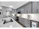Bright kitchen featuring stainless steel appliances, gray cabinets, quartz countertops, and modern finishes at 1948 Marsh Oak Ln, Seabrook Island, SC 29455