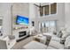 Bright living room features a fireplace, modern ceiling fan, and balcony with marina views at 1948 Marsh Oak Ln, Seabrook Island, SC 29455