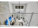Open living room featuring modern furniture, a stone accent wall, and plenty of natural light at 1948 Marsh Oak Ln, Seabrook Island, SC 29455