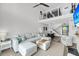 Spacious living room with ample seating and natural light, seamlessly connects to the dining area at 1948 Marsh Oak Ln, Seabrook Island, SC 29455